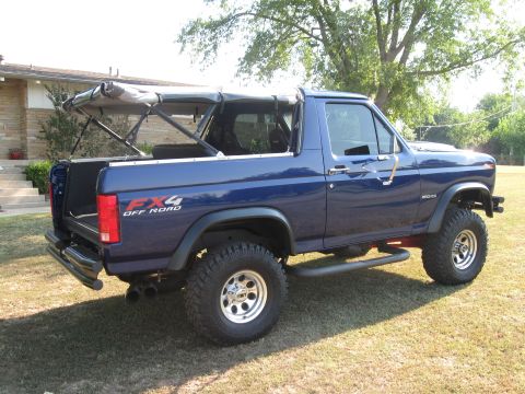 1982 Ford Bronco - 1982 Ford Bronco with FX4 Off Road decal parked on grass in front of a house.