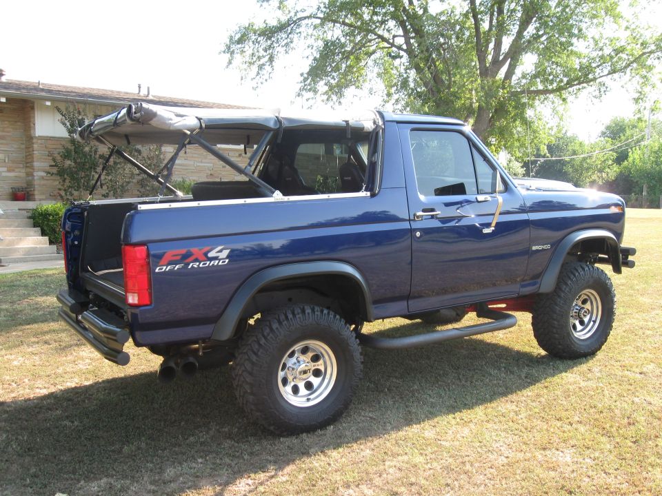 Blue 1982 Ford Bronco with FX4 Off Road decal and soft top removed