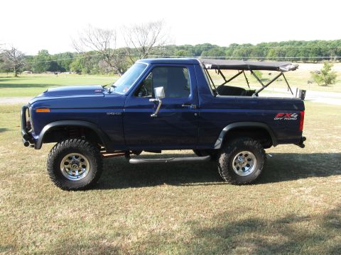 1982 Ford Bronco - 1982 Ford Bronco with FX4 Off Road decal and aftermarket wheels parked on grass.
