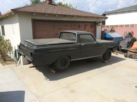 1968 Ford Mustang - A black 1960 Ford Falcon Ranchero sits on blocks in a driveway, awaiting restoration.