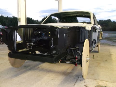 1967 Ford Mustang - A 1967 Ford Mustang body is shown from the front, stripped down for restoration work.