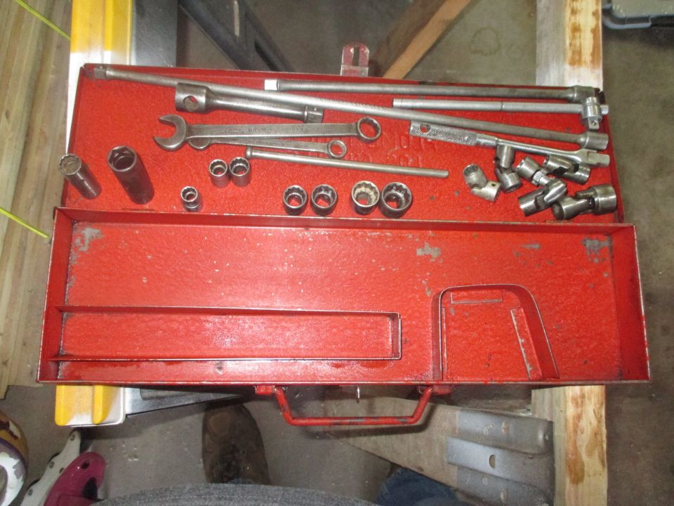 Red tool chest filled with sockets and wrenches