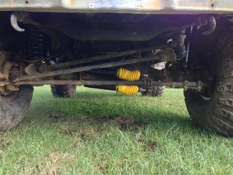 1979 Ford Bronco - Close-up of the undercarriage and suspension components of a 4x4 vehicle.
