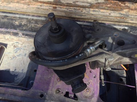 1979 Ford Bronco - A close-up view of a power steering pump assembly, showing its various components and mounting bracket.