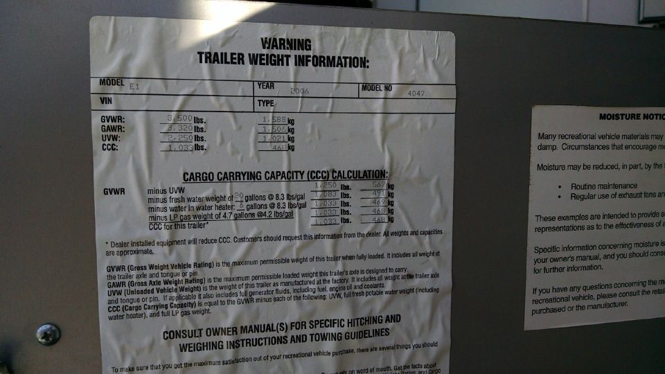 RV trailer weight information label with GVWR, GAWR, UVW and cargo carrying capacity calculation