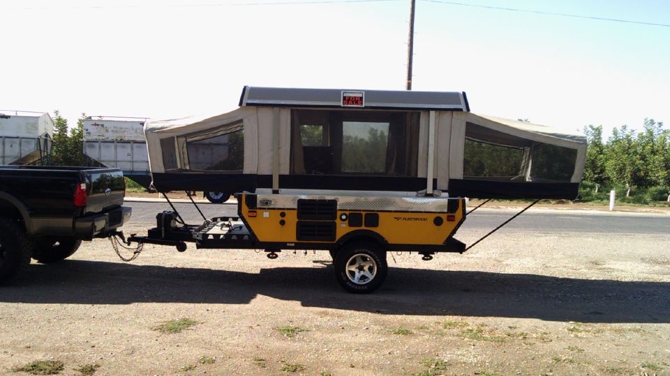 Yellow pop-up camper trailer side view