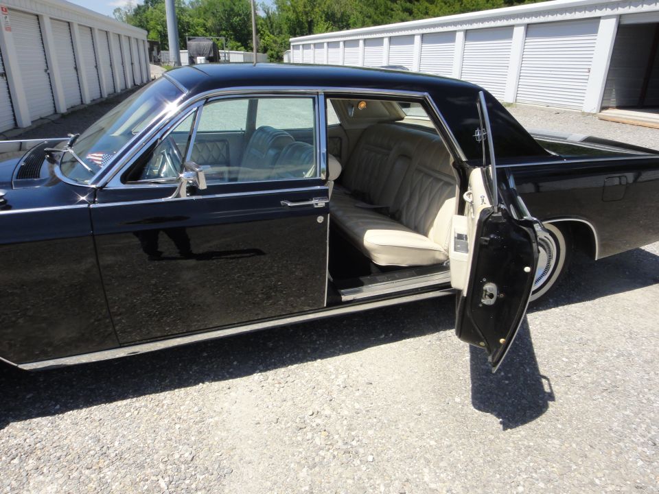 1968 Lincoln Continental, side view with open door, black exterior, beige interior