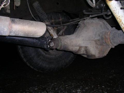 1990 Ford F-150 - Close-up view of the rear axle assembly and driveshaft of a vehicle.