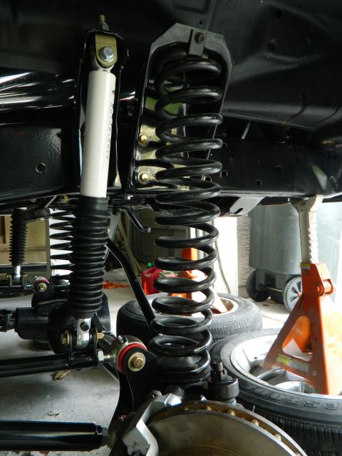 1979 Ford Bronco - Close-up view of a vehicle's front suspension system, prominent coil springs and shock absorbers.