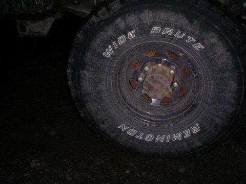 1990 Ford F-150 - Close-up of a tire and wheel with visible text branding.