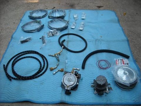 1979 Ford F-150 - A collection of assorted vehicle parts, including hoses and fittings, are neatly arranged on a blue blanket.