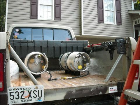 1979 Ford F-150 - The rear of a 1979 Ford F-150 pickup truck bed is shown with two propane tanks and a ladder.