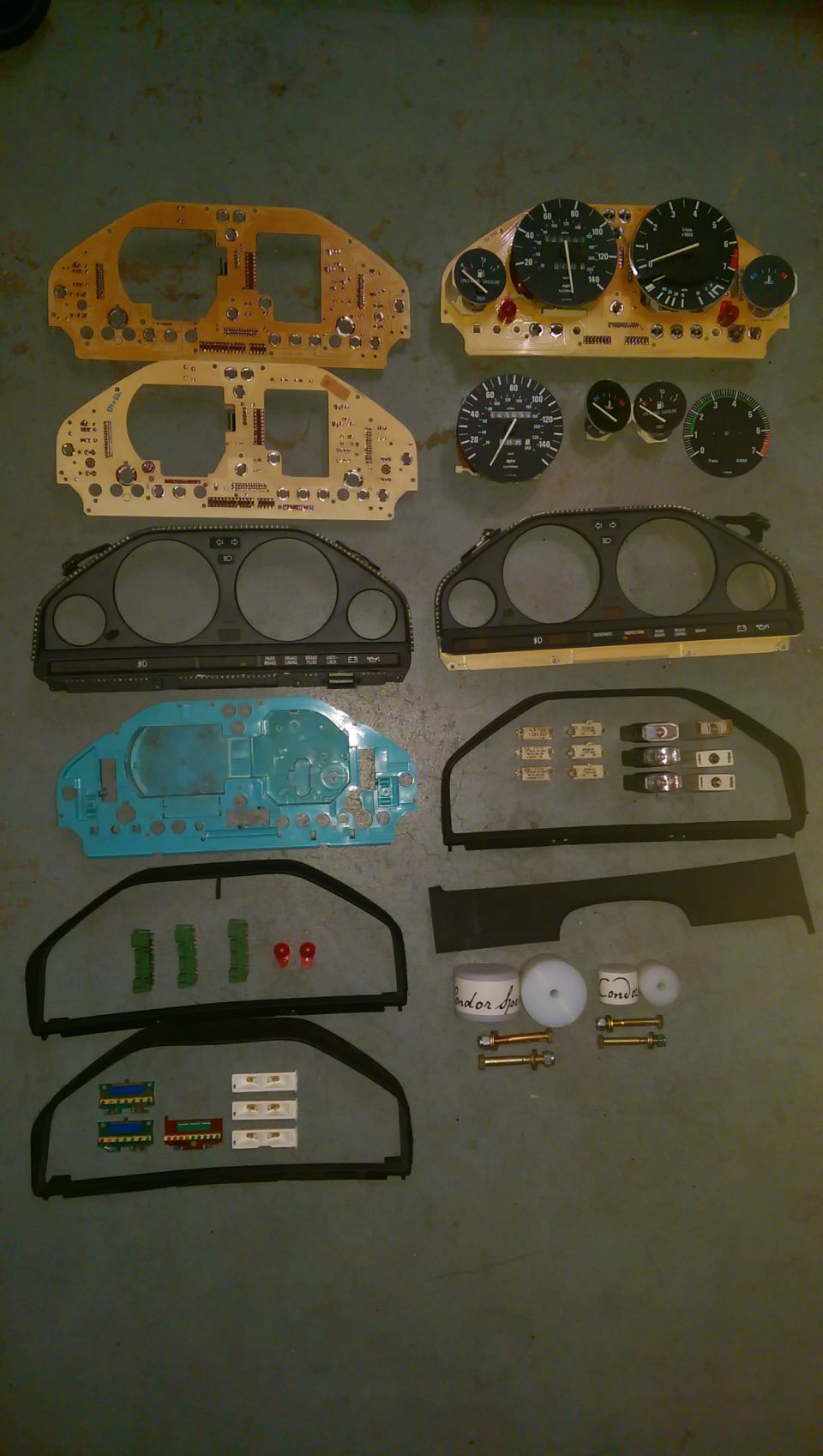BMW instrument cluster parts laid out on floor