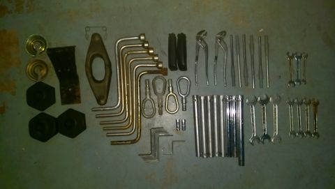 1989 BMW 3 Series - Various tools including wrenches, pliers, and sockets are neatly arranged on a flat surface.