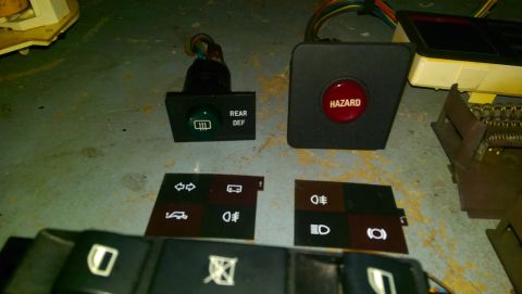 1989 BMW 3 Series - Hazard switch and rear defroster button are visible alongside other interior car buttons and switches.