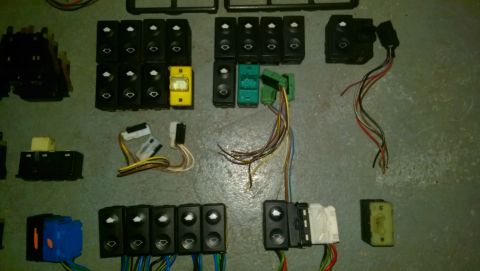 1989 BMW 3 Series - Various car window switches and electrical connectors are displayed, suggesting a parts inventory.