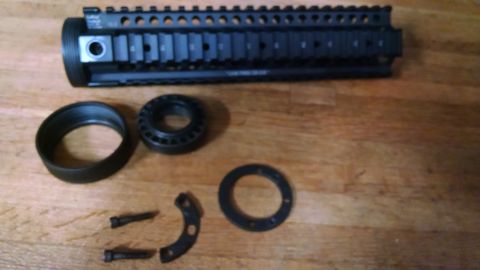 1996 Ford Bronco - Disassembled AR-15 handguard components laid out on a wooden table.