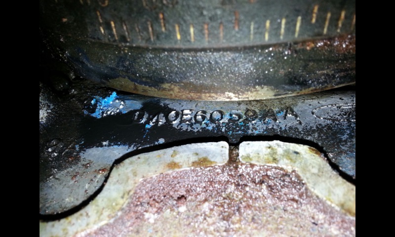 Close-up of a cast metal part stamped with part number D40860 SBAA