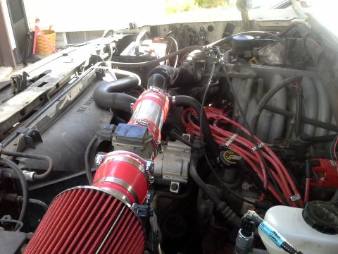 1996 Ford Bronco - Close-up view of an engine bay, highlighting a newly installed cold air intake system.