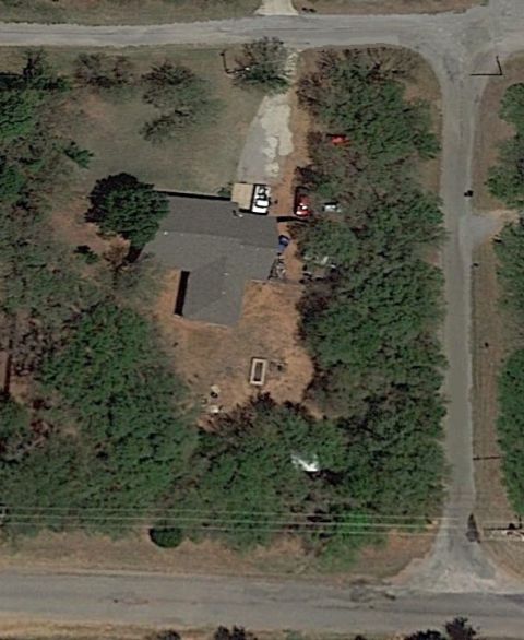 1965 Ford Mustang - An aerial view shows multiple vehicles parked in a residential area, including two red cars and one white car.
