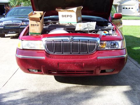 1999 Mercury Grand Marquis - Front view of a 1999 Mercury Grand Marquis with hood open, showing new headlight boxes.