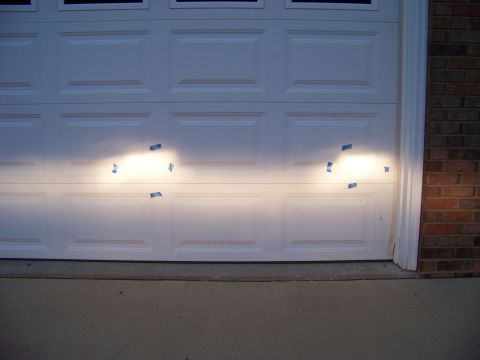 1999 Mercury Grand Marquis - Headlight beams are taped to a garage door, likely for alignment purposes.