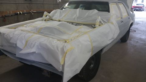 1991 Ford LTD Crown Victoria - A 1991 Ford Crown Victoria LTD is prepared for painting, with its engine bay and front end covered.