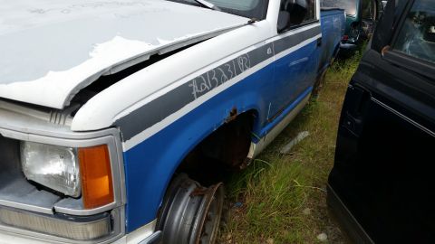 1991 Ford LTD Crown Victoria - This Chevrolet C/K pickup truck appears to be from the early 1990s, with visible rust and damage.