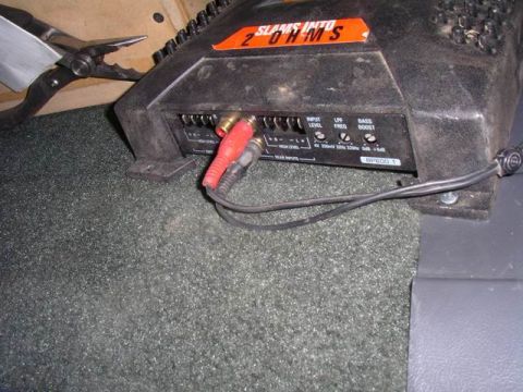 1990 Ford F-150 - A car stereo amplifier is shown with its input and output connections visible.