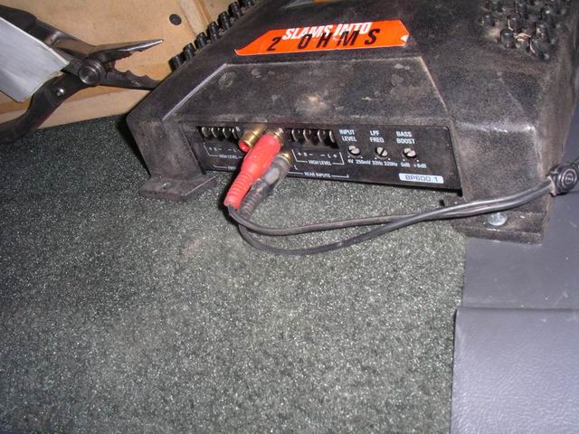 Car stereo amplifier with red and black RCA cables connected
