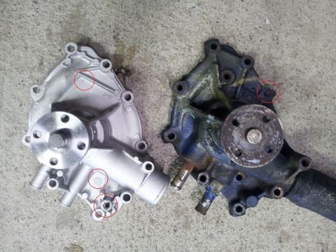 1968 Ford Mustang - Comparison of a new silver Ford water pump next to an older, used dark blue/black water pump.