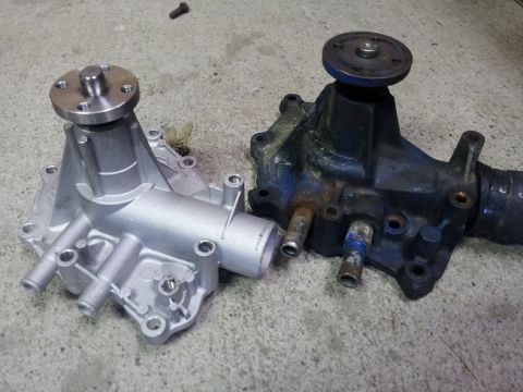 1968 Ford Mustang - A new water pump is shown next to an old, corroded one, likely for comparison or replacement.