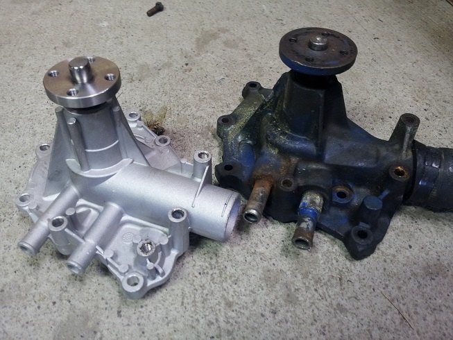 New silver water pump next to old blue and rusty one