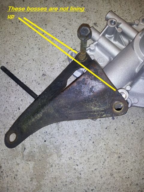1968 Ford Mustang - A close-up shows an engine bracket with yellow lines indicating an alignment problem with mounting bosses.