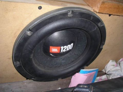 1990 Ford F-150 - A close-up view of a JBL 1200 subwoofer installed in a custom enclosure.