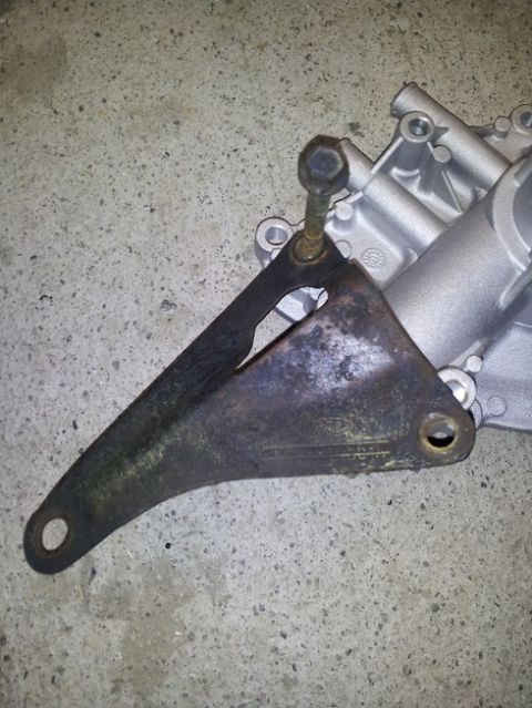 1968 Ford Mustang - A close-up view of a used engine bracket, showing signs of wear and tear.