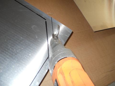 1992 Ford Bronco - Cutting sheet metal with electric shears.