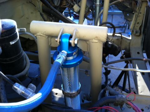 1995 Ford Bronco - Close-up of a blue Koni shock absorber mounted in a vehicle's engine bay, custom tubing and suspension components.