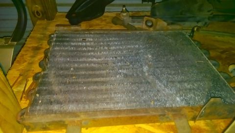 1989 BMW 3 Series - A close-up view of a vehicle's radiator or condenser unit, showing its metallic fins and tubing.