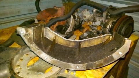 1989 BMW 3 Series - An engine part is shown on a yellow surface, with other engine components in the background.