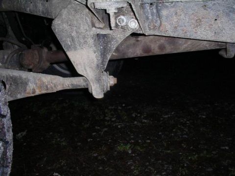 1990 Ford F-150 - Underside view of a heavily used truck suspension part, showing rust and wear.