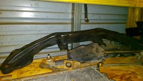 1989 BMW 3 Series - A black, curved metal part is shown, likely from a vehicle's undercarriage or frame.