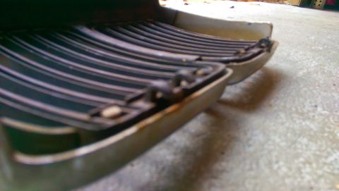 1989 BMW 3 Series - Close-up of a car grille part, viewed from a low angle, with visible wear and tear.