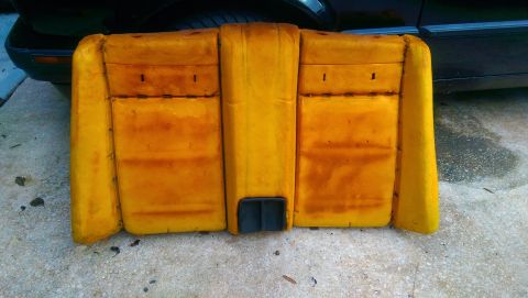 1989 BMW 3 Series - This is a yellow seat foam cushion, likely from a car's interior, with a black vent in the center.