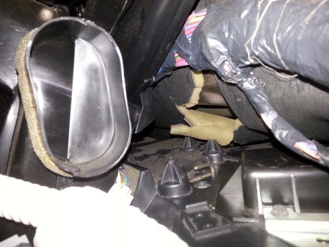 2003 Ford Crown Victoria - Interior view of a car's air duct system with exposed wiring and insulation material.