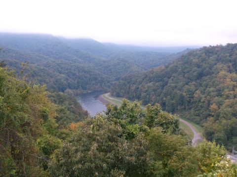 2011 Harley-Davidson Elec Gld Police - A landscape unfolds in a misty mountain valley, a tranquil river and a curving road through the trees.