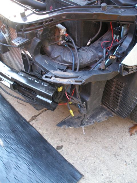 2008 Hyundai Accent - Front end of a car with parts removed, exposing the radiator and wiring harness.