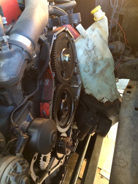 1997 Dodge 3500 - Engine timing gears are exposed, with hoses and a coolant reservoir in the background.