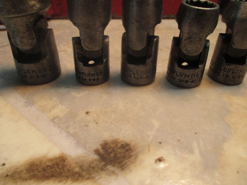 Several universal joint socket extensions with 'PLOMB' and 'MADE IN U.S.A.' visible
