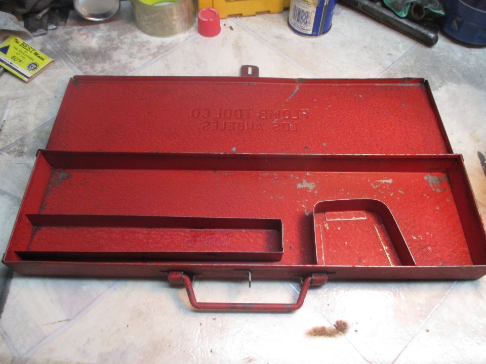 Red metal toolbox with "STROM TOOL CO LOS ANGELES" stamped on lid